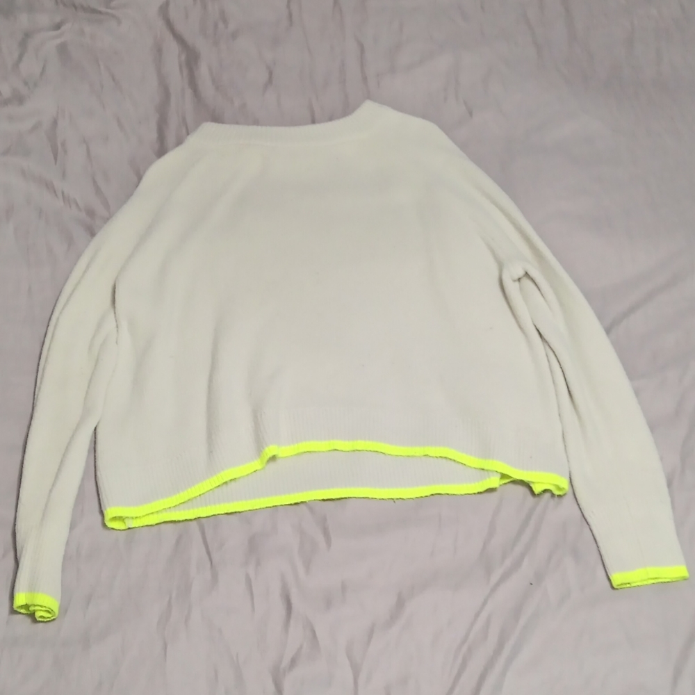 White sweater with green sleeves